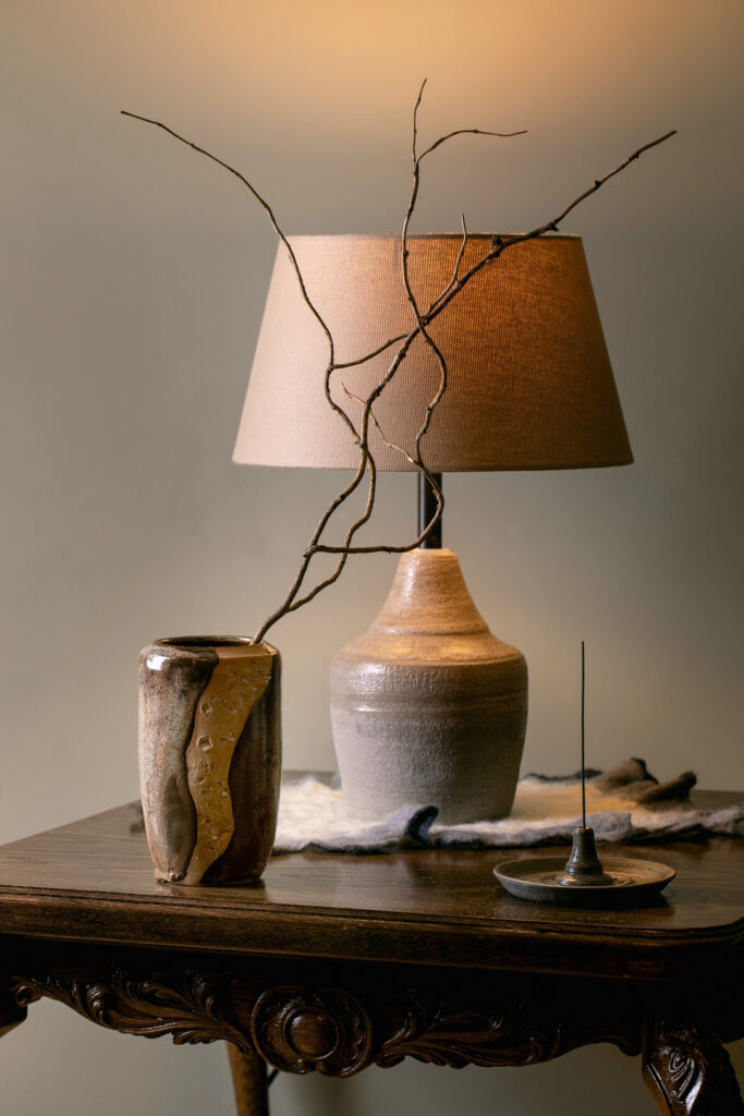 Home interior with beige handcrafted ceramic vase